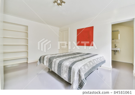 Luxurious bedroom with soft bed and fluffy bedspread 84581061