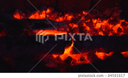 Burning coals in the open air. 84581817
