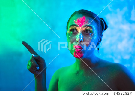 Portrait of woman in colorful neon lighting. Portrait of woman in colorful neon lighting. 84582827