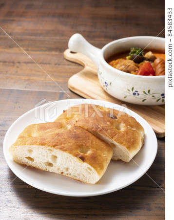 Tomato stew and focaccia 84583433