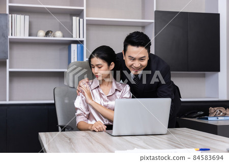 A Boss touching the shoulder of employee colleague in workplace at office. A Boss touching the shoulder of employee colleague in workplace at office. 84583694