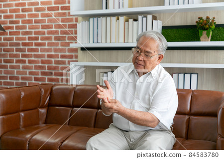 Male arms holding his painful wrist caused by Carpal tunnel syndrome, arthritis, neurological disease concept. Numbness of the hand Male arms holding his painful wrist caused by Carpal tunnel syndrome, arthritis, neurological disease concept. Numbness of the hand 84583780