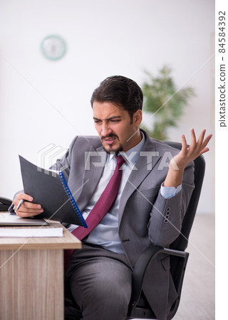 Young male employee working in the office 84584392