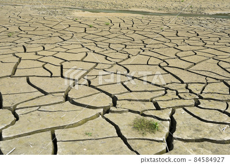 dry lake bed with a natural texture of cracked clay on the perspective ground.  84584927