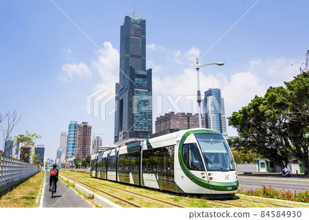 Cityscape of light rail train and the metropolitan building in Kaohsiung, Taiwan. The light rail system in Kaohsiung is the first light rail transit in Taiwan. 84584930