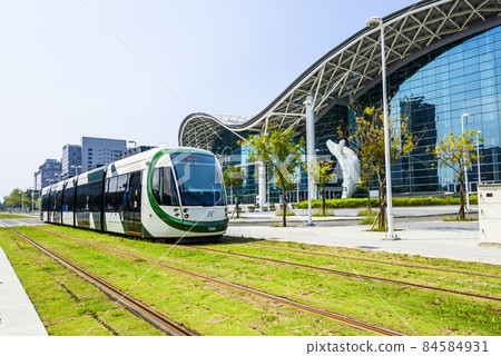 Cityscape of light rail train and the metropolitan building in Kaohsiung, Taiwan. The light rail system in Kaohsiung is the first light rail transit in Taiwan. 84584931