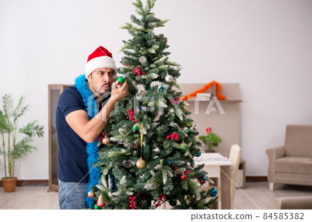 Young man celebrating Christmas at home 84585382