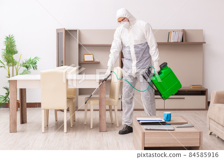 Young male contractor doing pest control at home 84585916