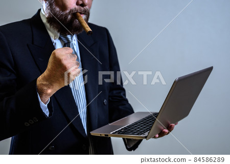 Elderly man holding his fist in front of a laptop and getting angry Pressure threatening complaints Anti-company black company gangsters 84586289