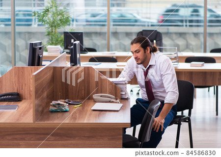 Young male employee and too many work in the office Young male employee and too many work in the office 84586830