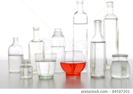 Bottles and cups of colored water Bottles and cups of colored water 84587201