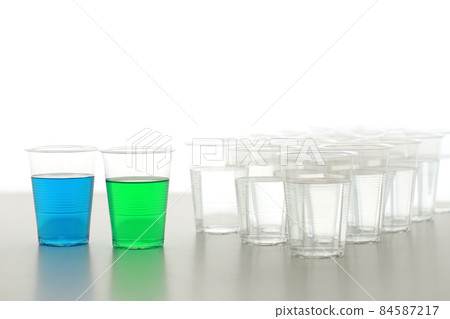Bottles and cups of colored water Bottles and cups of colored water 84587217