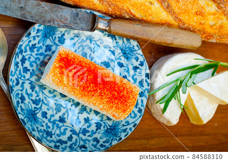 French cheese and fresh  baguette on a wood cutter 84588310