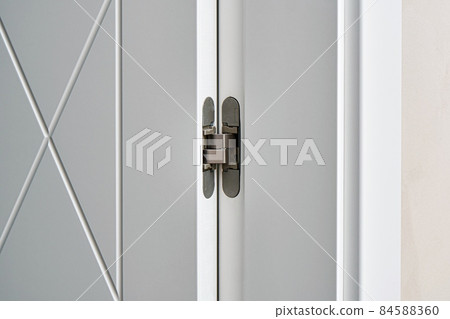 Contemporary door with rhombus pattern and hinge in room Contemporary door with rhombus pattern and hinge in room 84588360