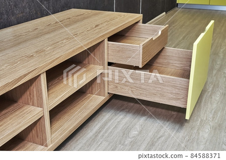 Elegant TV stand of oak veneer with yellow facade and open drawers Elegant TV stand of oak veneer with yellow facade and open drawers 84588371