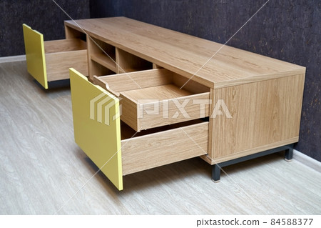Elegant TV stand of oak veneer with yellow facade and open drawers Elegant TV stand of oak veneer with yellow facade and open drawers 84588377
