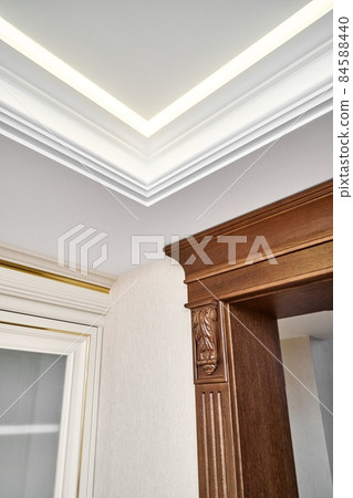 Wooden doorway near vintage display with glass door in light room 84588440