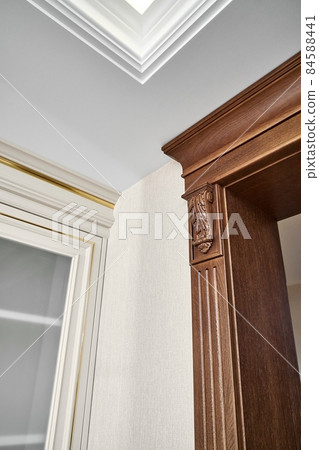 Wooden doorway near vintage display with glass door in light room Wooden doorway near vintage display with glass door in light room 84588441