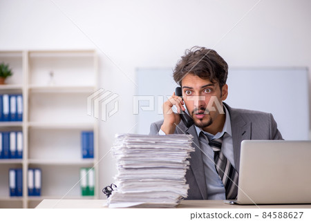 Young businessman employee and too much work in the office 84588627