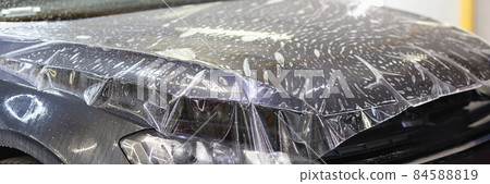 Polyurethane vinyl film pasted on hood of car closeup 84588819