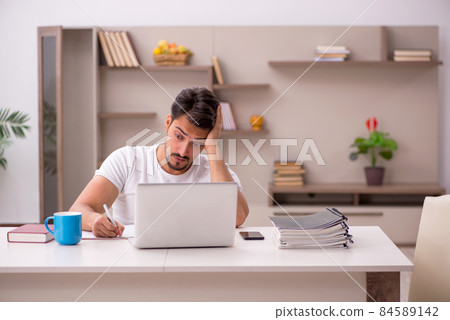 Young male employee working from home during pandemic 84589142