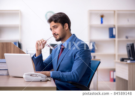 Young male employee working in the office 84589148
