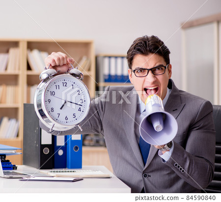 Businessman with loudspeaker megaphone in office Businessman with loudspeaker megaphone in office 84590840