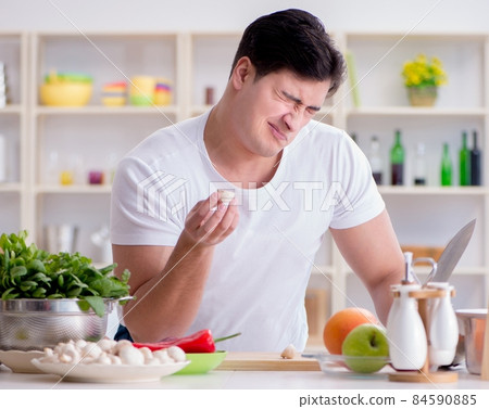 Young male cook working in the kitchen Young male cook working in the kitchen 84590885