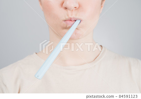 Close-up portrait of caucasian woman brushing her teeth. The girl performs the morning oral hygiene procedure Close-up portrait of caucasian woman brushing her teeth. The girl performs the morning oral hygiene procedure 84591123