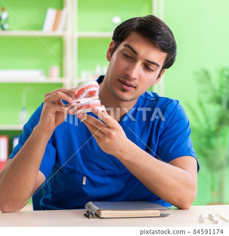 Man dentist working on new teeth implant 84591174