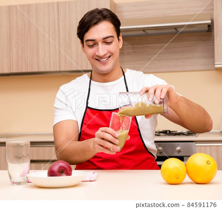 Handsome man working at the kitchen Handsome man working at the kitchen 84591176