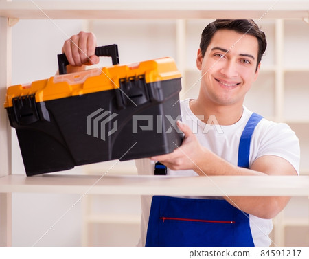 Worker man repairing assembling bookshelf 84591217