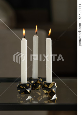 Set of stone Candle Holder with abstract smudges, cracks black concrete with golden flame. selective soft focus 84592754