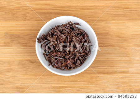 Top view of a white bowl with used tea leaves. Top view of a white bowl with used tea leaves. 84593258