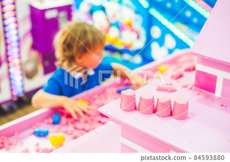 Boy playing with kinetic sand in preschool. The development of fine motor concept. Creativity Game concept Boy playing with kinetic sand in preschool. The development of fine motor concept. Creativity Game concept 84593880