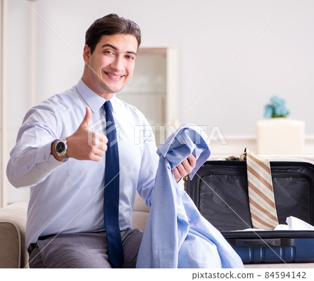 Businessman preparing for the business trip Businessman preparing for the business trip 84594142