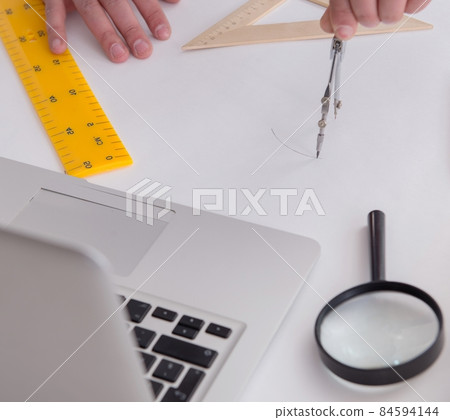 Male engineer working on drawings and blueprints Male engineer working on drawings and blueprints 84594144
