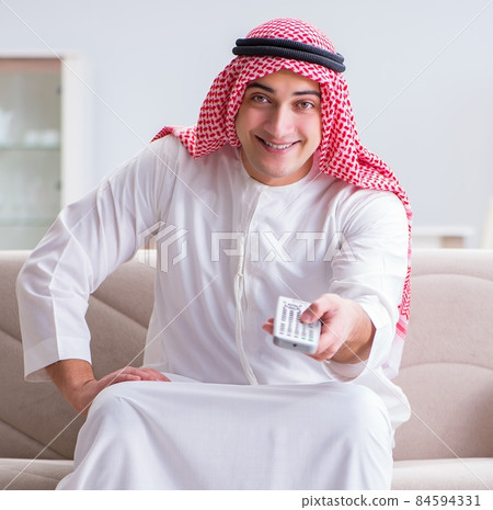 Arab man watching sport football at tv Arab man watching sport football at tv 84594331