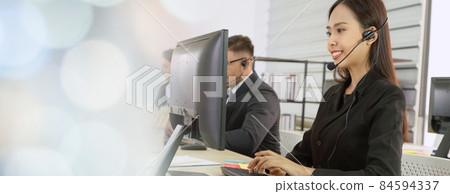 Business people wearing headset working in office broaden view Business people wearing headset working in office broaden view 84594337