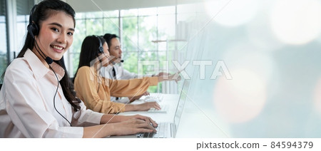 Business team wearing headset working actively in office Business team wearing headset working actively in office 84594379