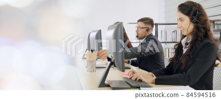 Business people wearing headset working in office broaden view 84594516