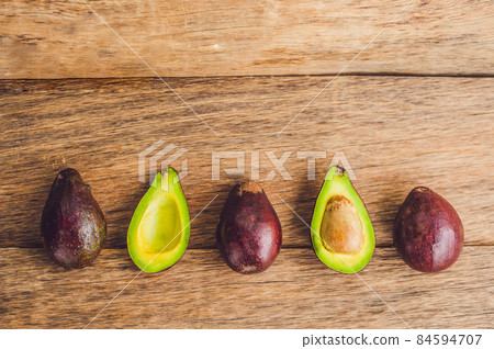 Fresh organic avocado on dark old wooden table, side view Fresh organic avocado on dark old wooden table, side view 84594707