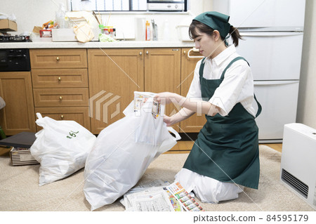Female worker cleaning up a messy room 84595179