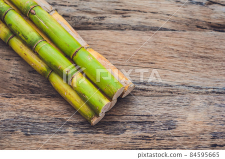 Stalks of sugar cane on the old wooden background 84595665