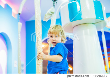 Young boy thrilled on the carousel ride 84596617