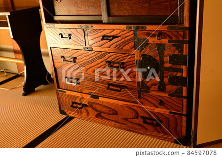 A chest of drawers in an old folk house 84597078