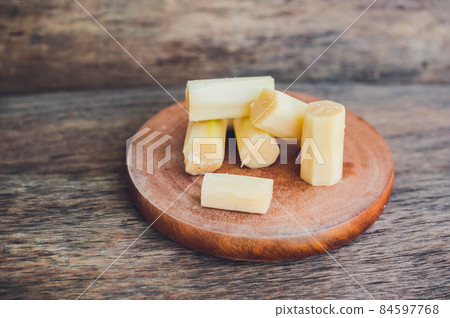 Pieces of cane sugar on the old wooden background. Sugar concept 84597768