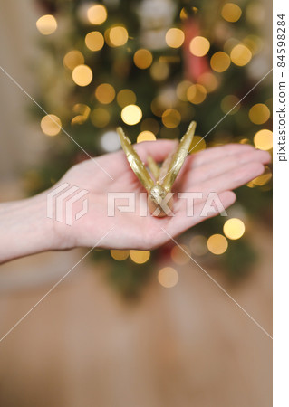 hand holding toy and decorating Christmas tree. Holiday, Christmas and New Year celebration concept hand holding toy and decorating Christmas tree. Holiday, Christmas and New Year celebration concept 84598284