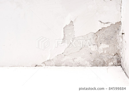Fungus and mold on the wall in the damp corner of the house. Loose plaster, problems with poorly built housing and a humid climate Fungus and mold on the wall in the damp corner of the house. Loose plaster, problems with poorly built housing and a humid climate 84599884