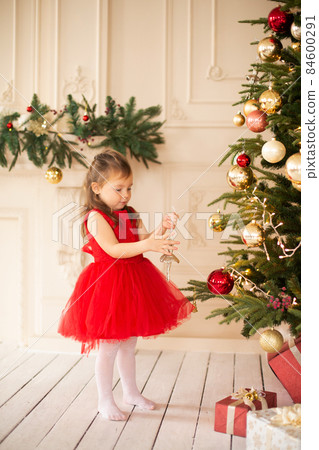 Little girl excited for christmas holidays with all these gifts and fairytale decoration Little girl excited for christmas holidays with all these gifts and fairytale decoration 84600291